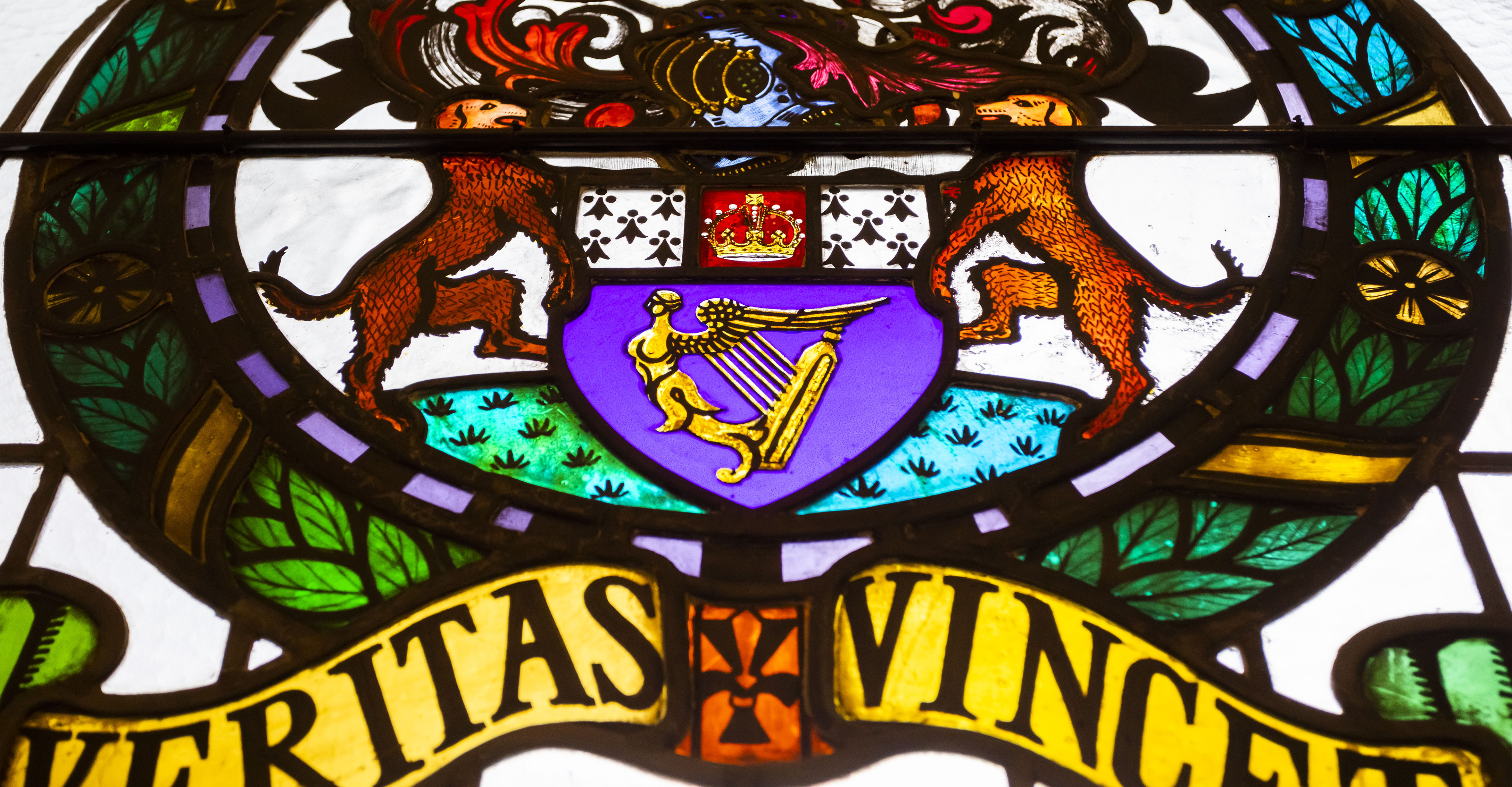 A stained glass window with the Law Society motto Veritas vincet, meaning 'truth will triumph'