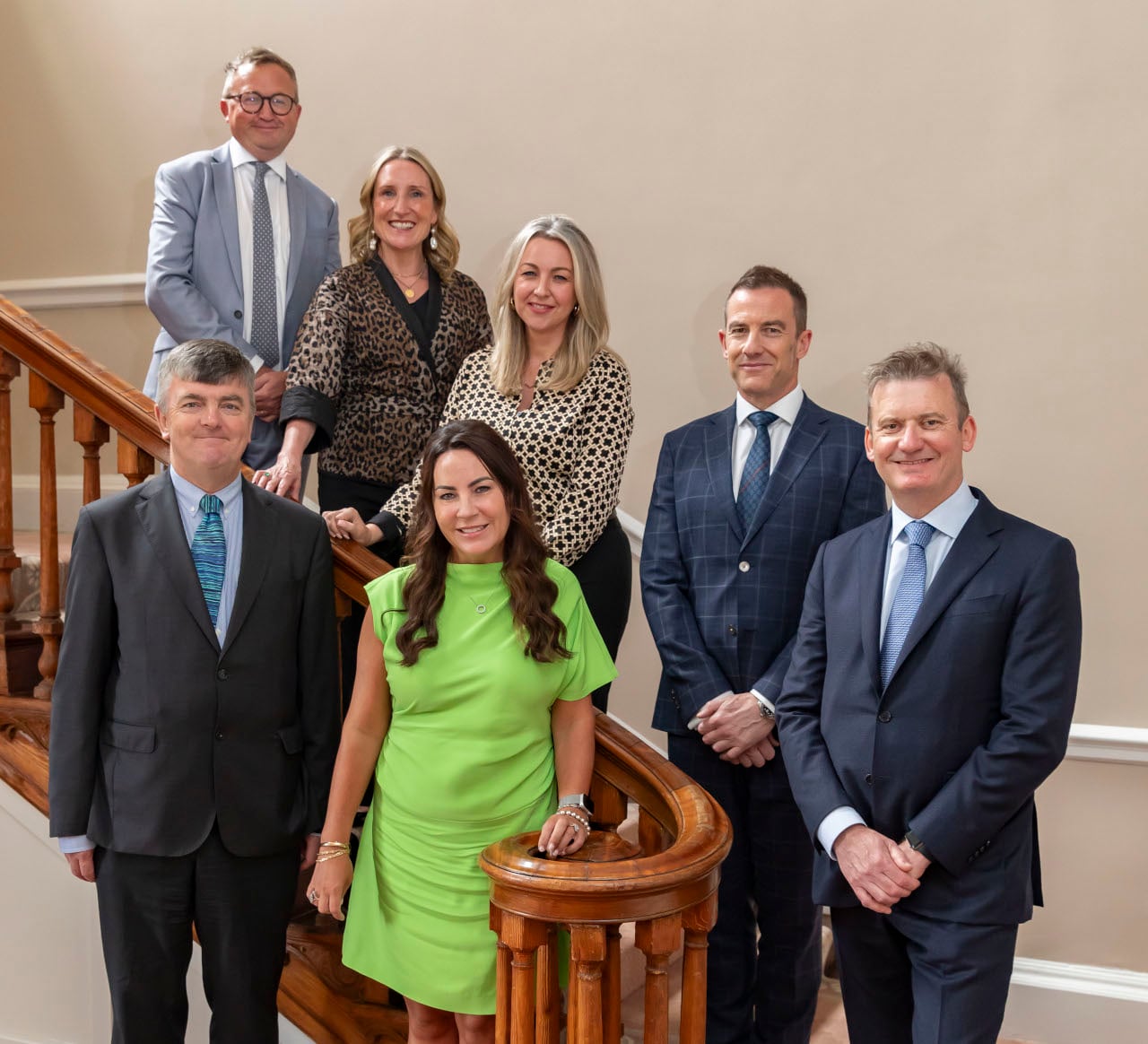 Group of professional directors standing on a flight of stairs