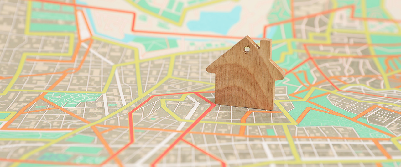 A wooden figure of property on a stree map