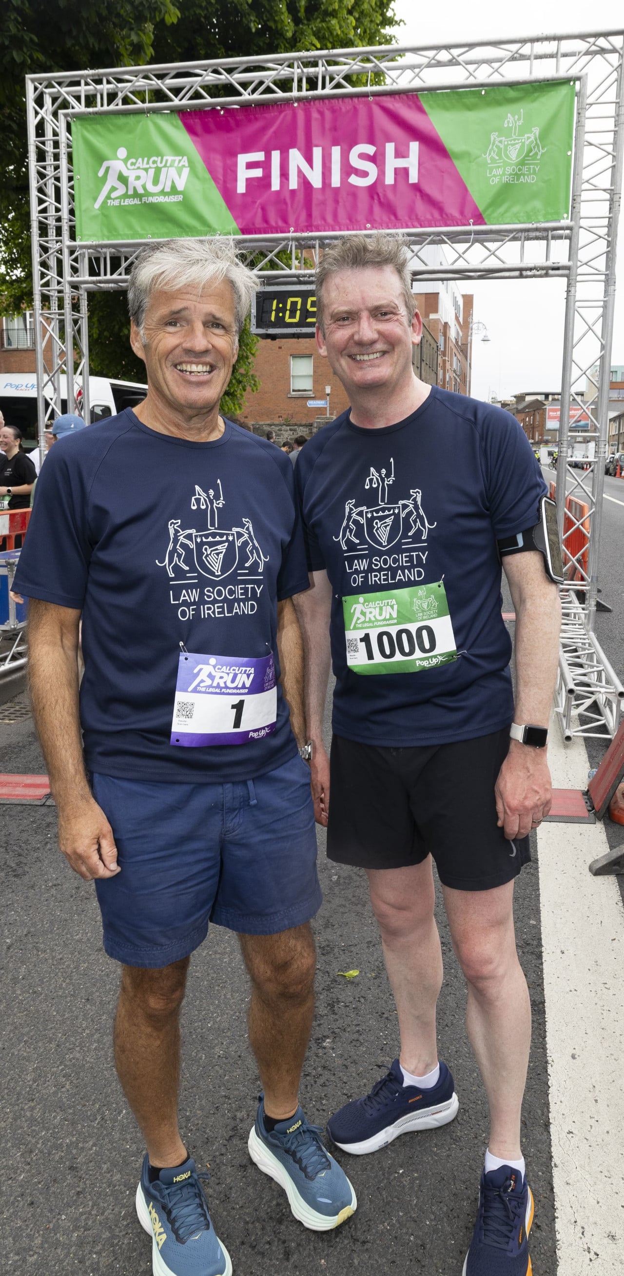 President Eamon Harrington and Director General Mark Garrett cross the finishing line at the 2025 Calcutta Run Mark Garrett and Eamonn Harrington