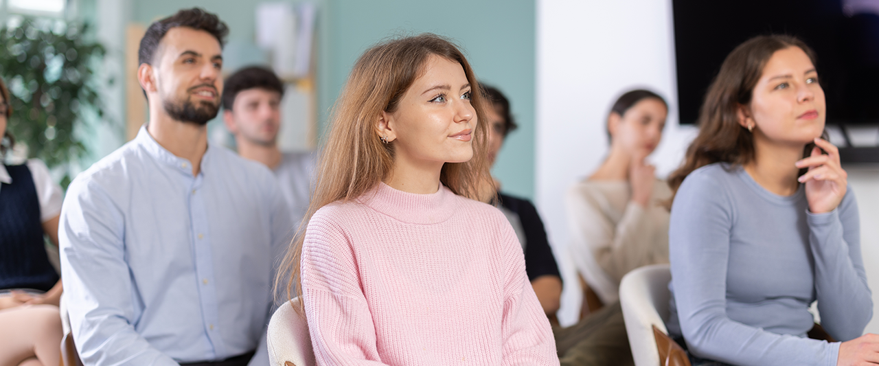 A group of students paying attention to a presentation
